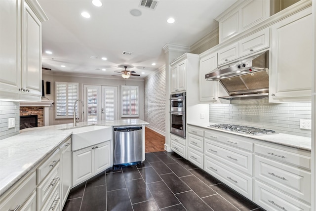 kitchen with white cabinetry, kitchen peninsula, and appliances with stainless steel finishes