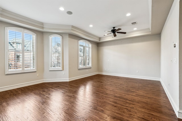 unfurnished room featuring ceiling fan, dark wood-type flooring, crown molding, and a healthy amount of sunlight