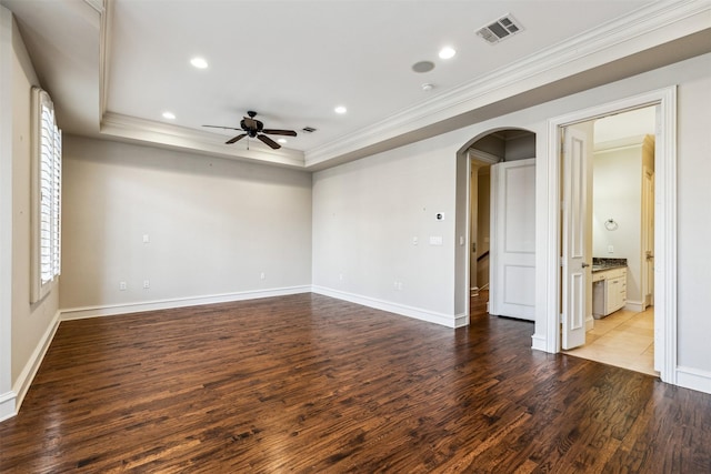 empty room with ceiling fan, light hardwood / wood-style floors, crown molding, and a tray ceiling