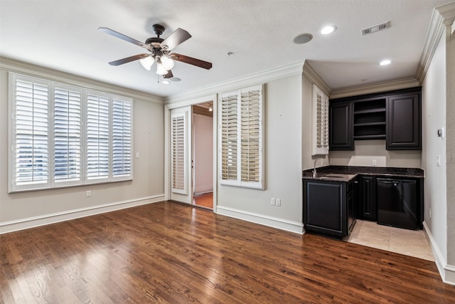 interior space featuring dark hardwood / wood-style floors, sink, black dishwasher, and ornamental molding