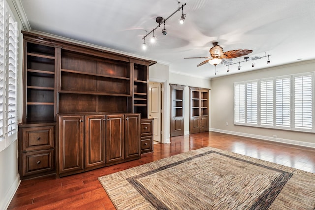 unfurnished living room featuring track lighting, ceiling fan, dark hardwood / wood-style floors, and ornamental molding