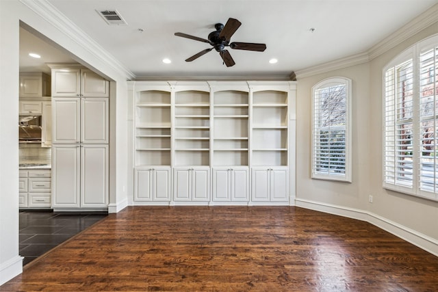 unfurnished living room with ceiling fan, ornamental molding, and dark wood-type flooring