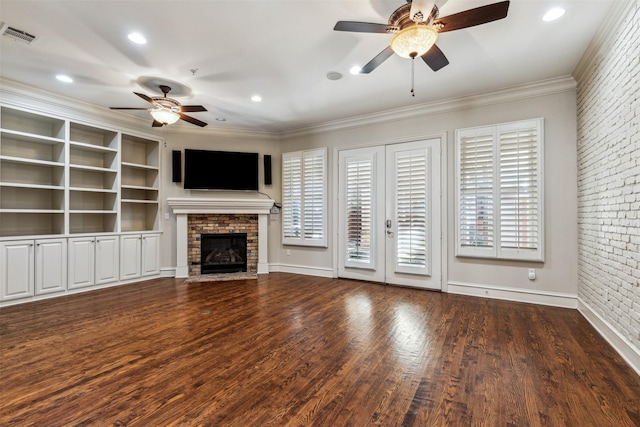 unfurnished living room with brick wall, french doors, ceiling fan, dark hardwood / wood-style flooring, and ornamental molding