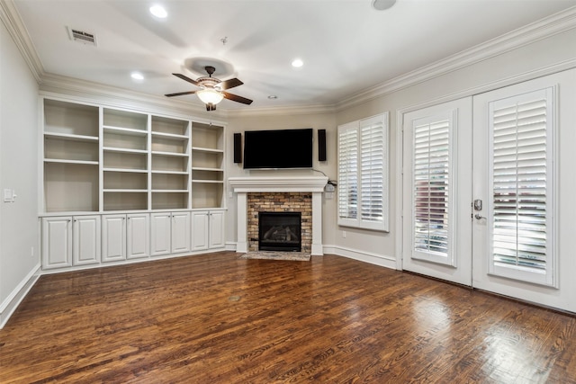 unfurnished living room with a brick fireplace, crown molding, dark hardwood / wood-style floors, and ceiling fan