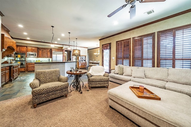 living room featuring ceiling fan with notable chandelier, crown molding, and a wealth of natural light