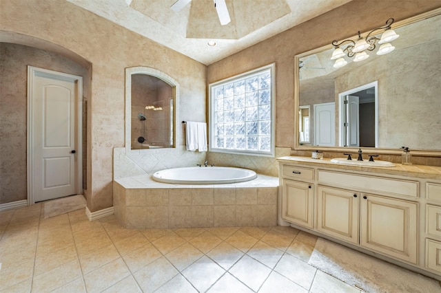 bathroom featuring shower with separate bathtub, ceiling fan, tile patterned flooring, and vanity