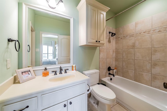 full bathroom with tiled shower / bath combo, vanity, and toilet