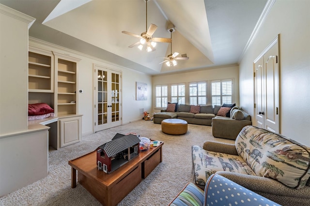 carpeted living room featuring vaulted ceiling, a tray ceiling, ceiling fan, french doors, and ornamental molding