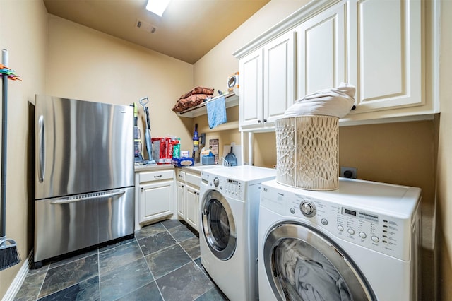 laundry area featuring cabinets and separate washer and dryer