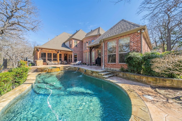 view of swimming pool with pool water feature and a patio area