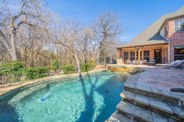 view of swimming pool with a patio area and an in ground hot tub