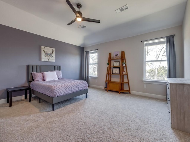 bedroom featuring visible vents, multiple windows, and light colored carpet