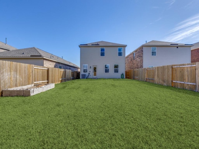 back of property with a yard, central AC, and a fenced backyard