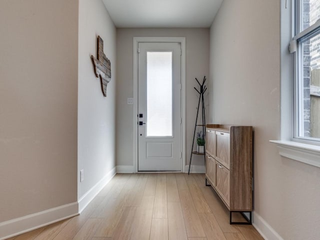 entryway featuring baseboards and light wood-style floors