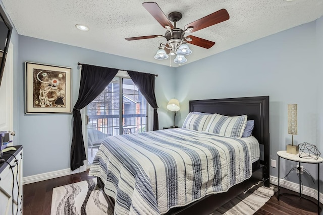 bedroom with dark wood-style flooring, a textured ceiling, and baseboards