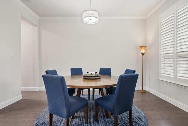 dining room featuring baseboards, ornamental molding, and dark wood finished floors