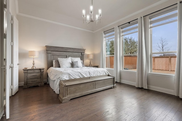 bedroom featuring ornamental molding, an inviting chandelier, and wood finished floors