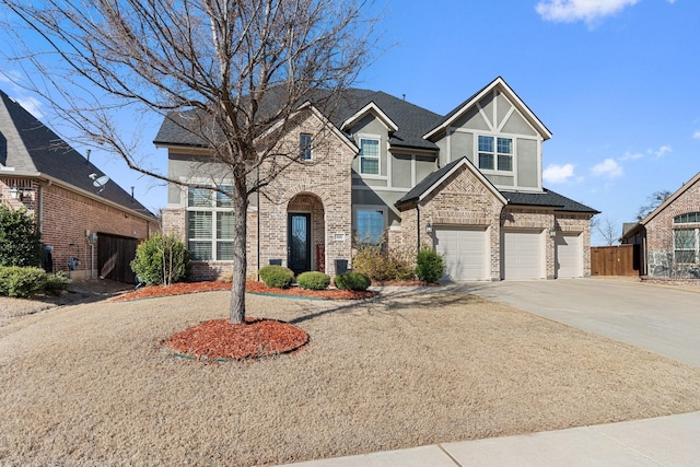 view of front of home featuring brick siding, a shingled roof, concrete driveway, fence, and a garage