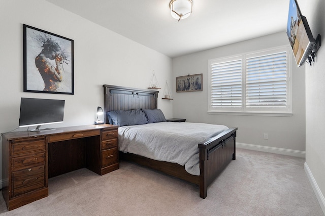 bedroom with light carpet and baseboards