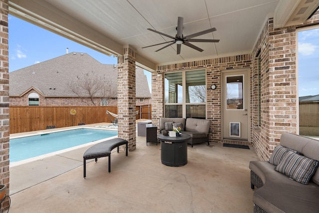 view of patio with ceiling fan, a fenced backyard, an outdoor living space, and a fenced in pool