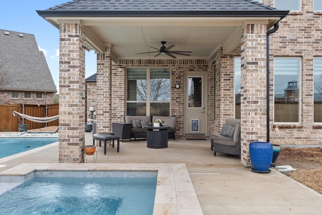 view of swimming pool featuring a fenced in pool, a patio, ceiling fan, fence, and outdoor lounge area