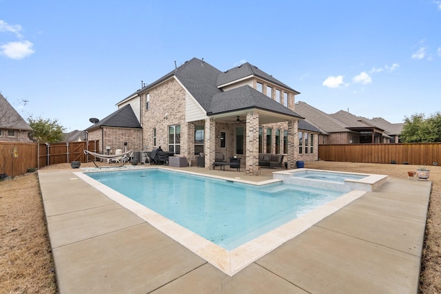 view of swimming pool featuring a patio, ceiling fan, a fenced backyard, a pool with connected hot tub, and outdoor lounge area