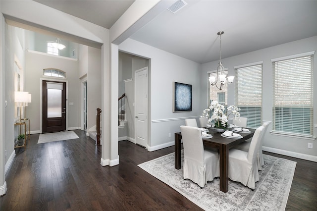 dining room featuring visible vents, stairway, an inviting chandelier, wood finished floors, and baseboards