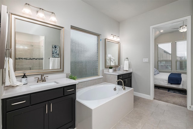 ensuite bathroom with tiled shower, a sink, a bath, and a ceiling fan