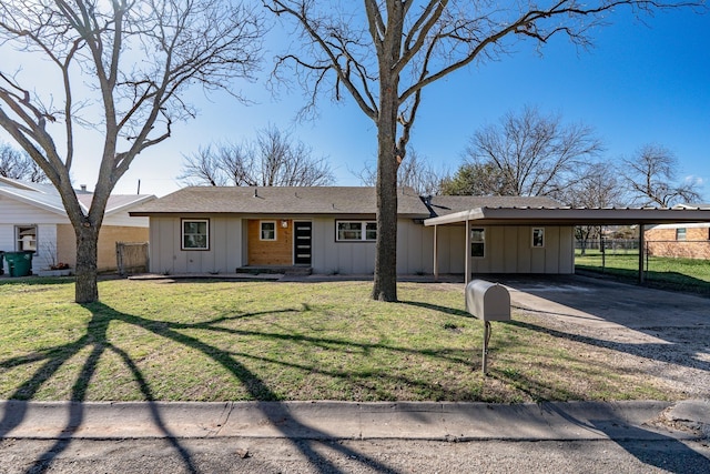 ranch-style home with a carport and a front yard