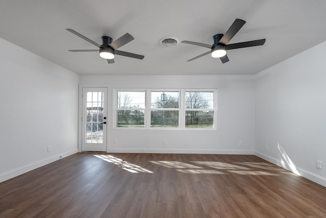 unfurnished room featuring ceiling fan and dark hardwood / wood-style flooring