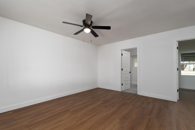 unfurnished bedroom featuring ceiling fan and dark wood-type flooring