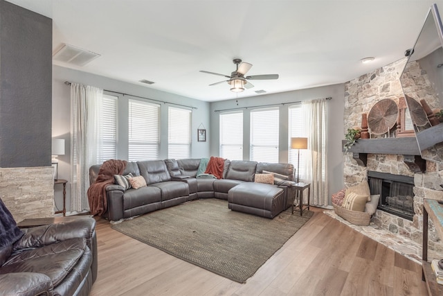2745 Sunlight Dr, Little Elm, TX 75068 - living room featuring a fireplace, ceiling fan, and light hardwood / wood-style floors
