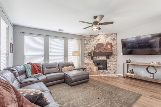 2745 Sunlight Dr, Little Elm, TX 75068 - living room with a fireplace, ceiling fan, and light wood-type flooring