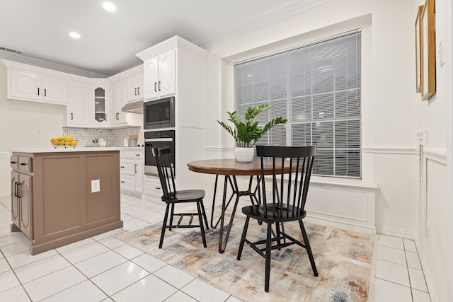 kitchen with white cabinetry, built in microwave, light tile patterned flooring, and wall oven