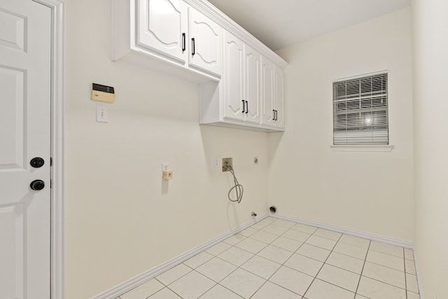 washroom featuring hookup for a gas dryer, washer hookup, electric dryer hookup, light tile patterned floors, and cabinets