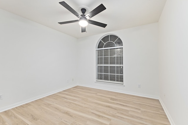 empty room with ceiling fan and light hardwood / wood-style floors