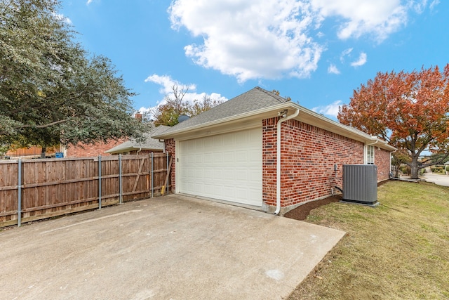 garage featuring a yard and cooling unit