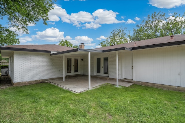 back of house with a patio, french doors, and a lawn