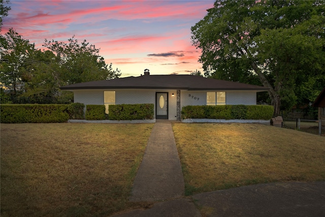 ranch-style house featuring a yard