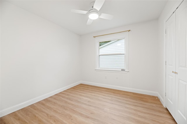 unfurnished bedroom featuring baseboards, a ceiling fan, a closet, and light wood-style floors