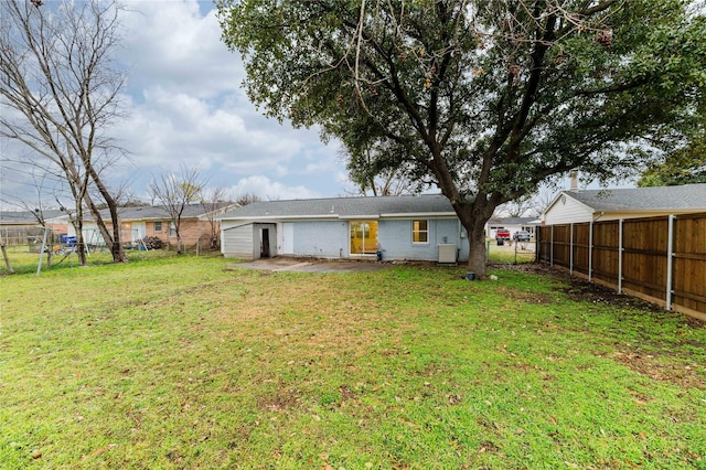 back of property with a lawn, a fenced backyard, and a patio area