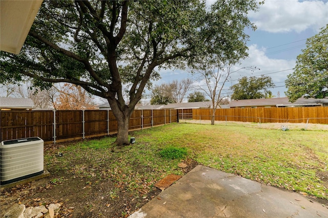 view of yard with central AC and a fenced backyard