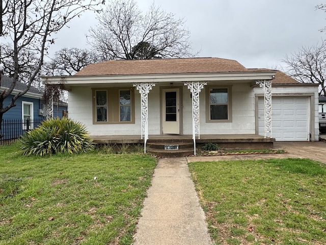 view of front of home with a porch, a front yard, and a garage