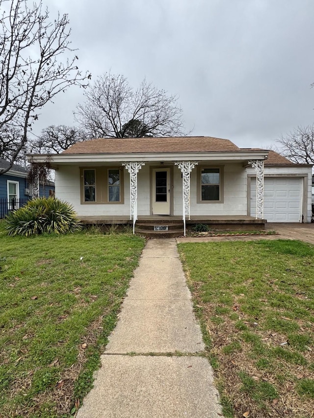 view of front of home with a garage and a front lawn