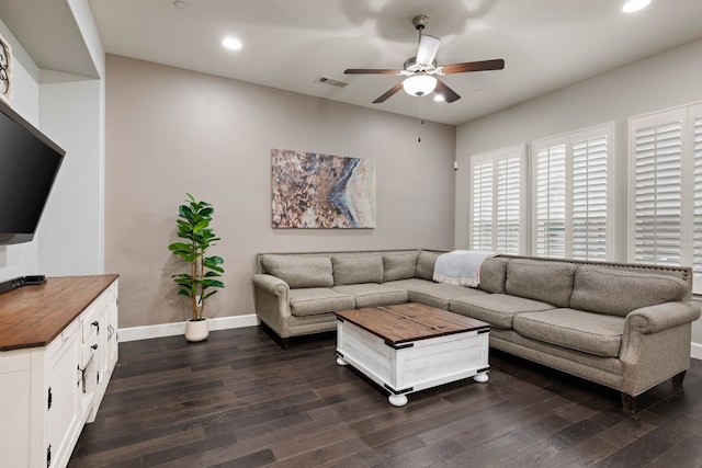 living room with ceiling fan and dark wood-type flooring