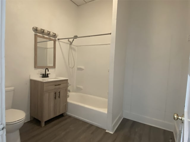 full bathroom with  shower combination, wood-type flooring, vanity, and toilet