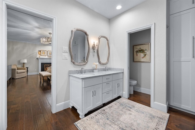 bathroom with vanity, a chandelier, toilet, and hardwood / wood-style floors