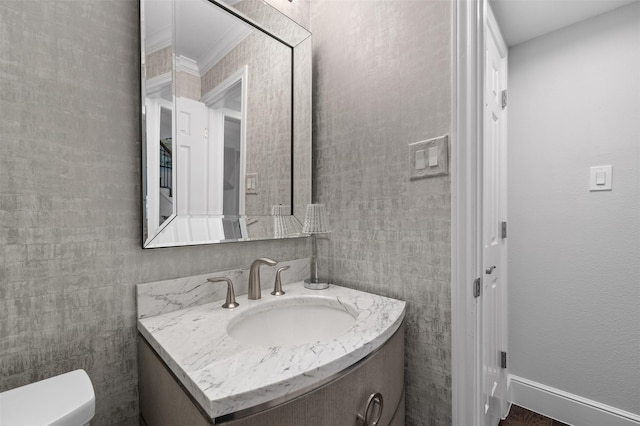 bathroom featuring tile walls, vanity, crown molding, and toilet