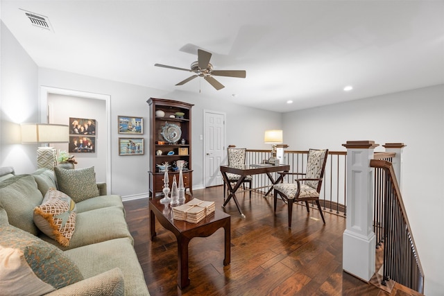 living room with dark hardwood / wood-style flooring and ceiling fan