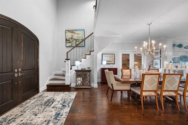 dining space with ornamental molding, dark wood-type flooring, and a chandelier